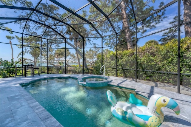 view of pool with a lanai, an in ground hot tub, and a patio