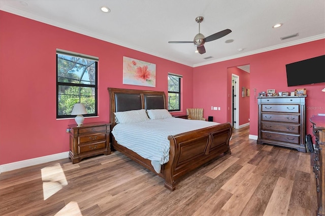 bedroom with wood-type flooring, ceiling fan, and ornamental molding