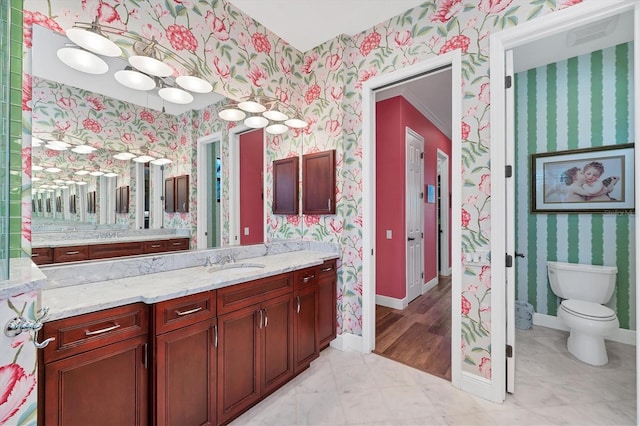 bathroom featuring vanity, toilet, and ornamental molding