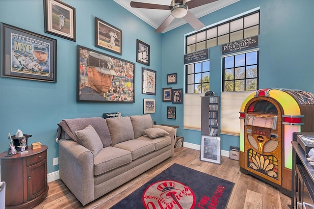 interior space with hardwood / wood-style flooring, ceiling fan, and crown molding