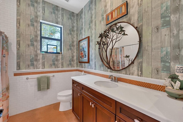 bathroom with tile patterned flooring, vanity, and toilet