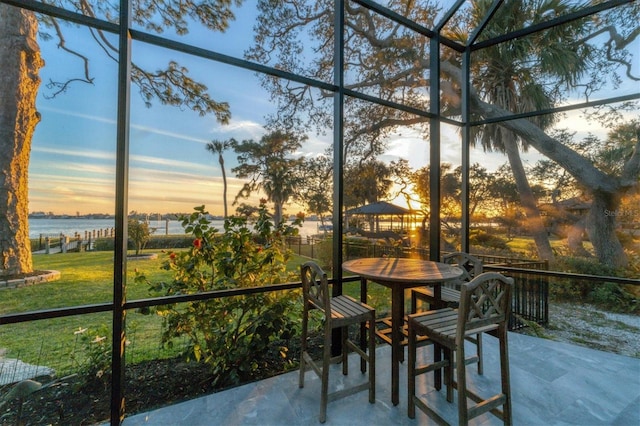 sunroom / solarium with a water view