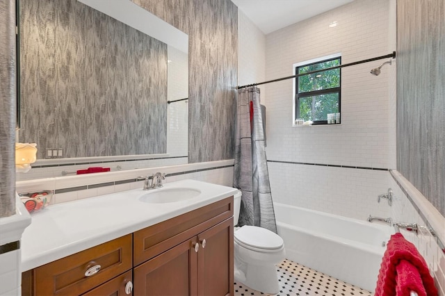 bathroom featuring tile walls, vanity, tile patterned floors, toilet, and shower / tub combo with curtain
