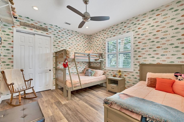 bedroom featuring light wood-style floors, recessed lighting, wallpapered walls, a ceiling fan, and visible vents
