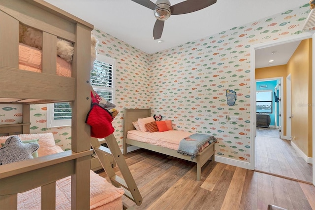 bedroom with light wood-type flooring, baseboards, and wallpapered walls