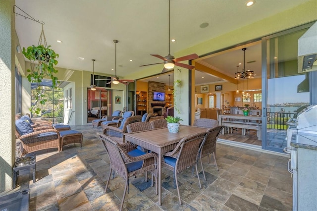 dining room with recessed lighting, stone finish flooring, and ceiling fan with notable chandelier