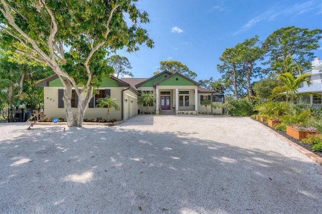 view of front of house featuring an attached garage, driveway, and stucco siding