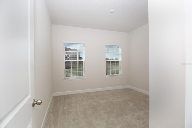 empty room featuring light colored carpet