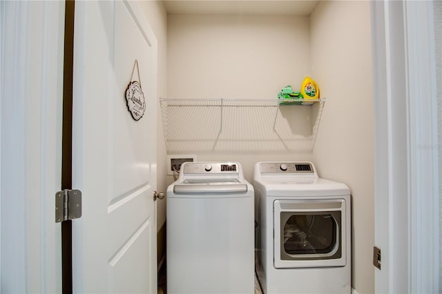 laundry area with independent washer and dryer