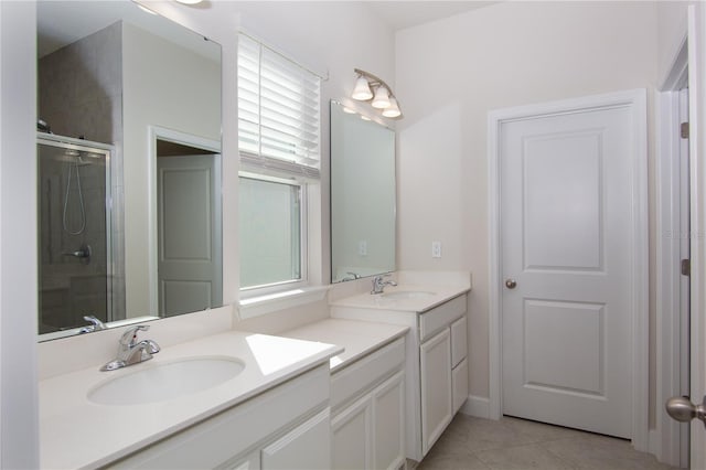 bathroom with tile patterned floors, vanity, and an enclosed shower