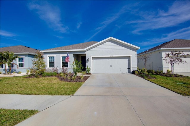 single story home with a front yard and a garage