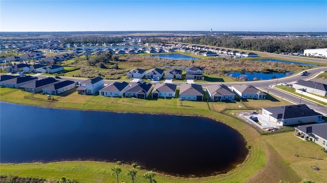 birds eye view of property with a water view and a residential view