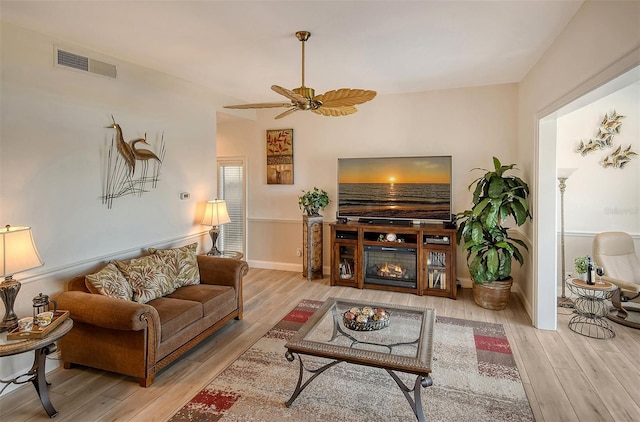 living room with hardwood / wood-style floors and ceiling fan