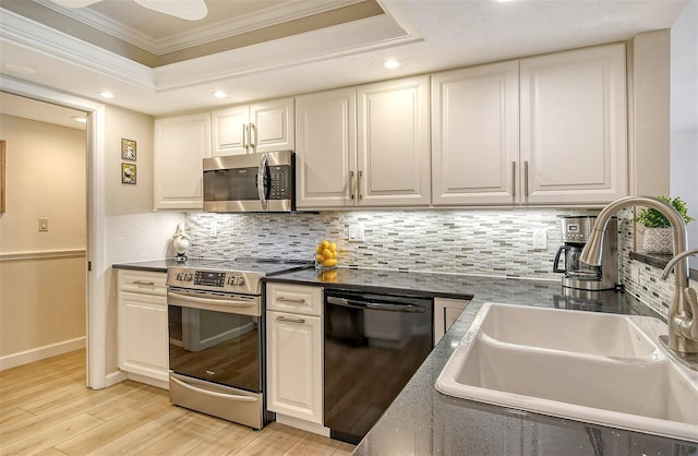 kitchen with sink, stainless steel appliances, light hardwood / wood-style flooring, crown molding, and decorative backsplash