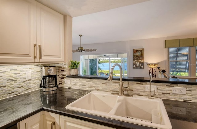 kitchen with ceiling fan, sink, and tasteful backsplash