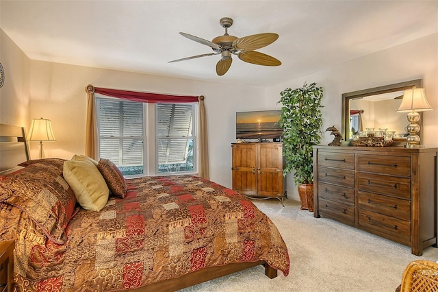 bedroom featuring ceiling fan and light carpet