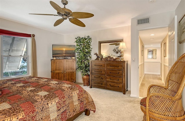 bedroom featuring ceiling fan and light colored carpet