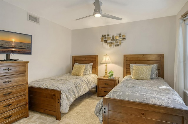 bedroom with ceiling fan and light colored carpet