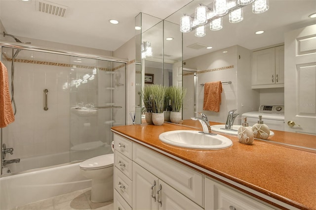 full bathroom featuring vanity, enclosed tub / shower combo, tile patterned flooring, washer / clothes dryer, and toilet