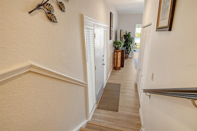 hall with light hardwood / wood-style floors