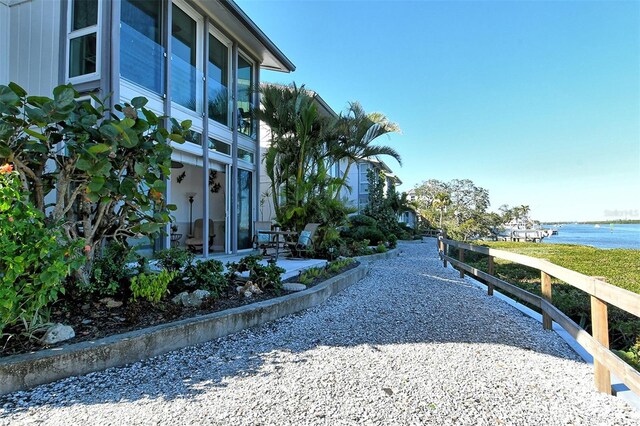 exterior space with a water view and a patio