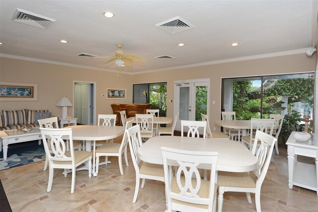 dining area featuring ceiling fan and ornamental molding