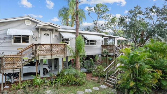 39200 Cook Brown Rd, Punta Gorda, FL 33982 - view of front of house with stairs, a deck, and a carport