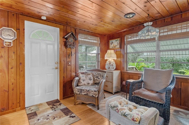 interior space featuring wood walls, wood ceiling, and light hardwood / wood-style flooring