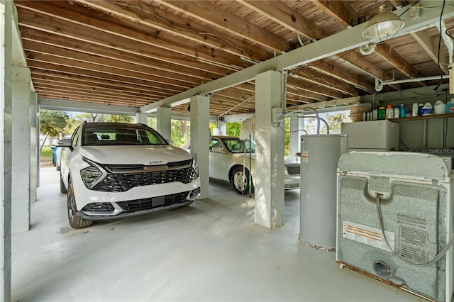 garage featuring water heater and white refrigerator