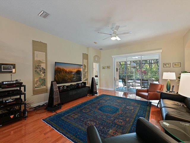 living room with hardwood / wood-style floors and ceiling fan