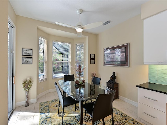 dining area with ceiling fan and light tile patterned flooring