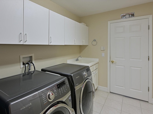 washroom with cabinets, separate washer and dryer, sink, and light tile patterned floors