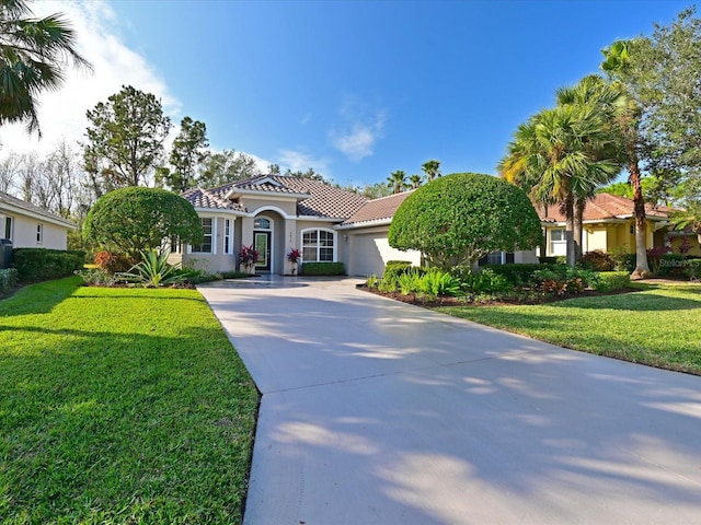 mediterranean / spanish home featuring a front lawn