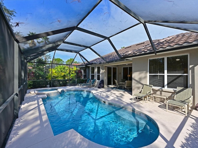 view of pool with a lanai, an in ground hot tub, and a patio