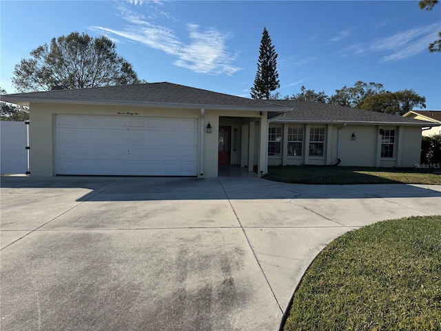 single story home featuring a garage and a front lawn