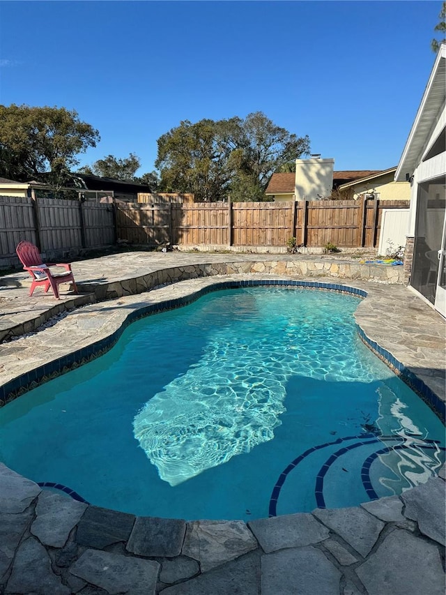 view of swimming pool with a patio