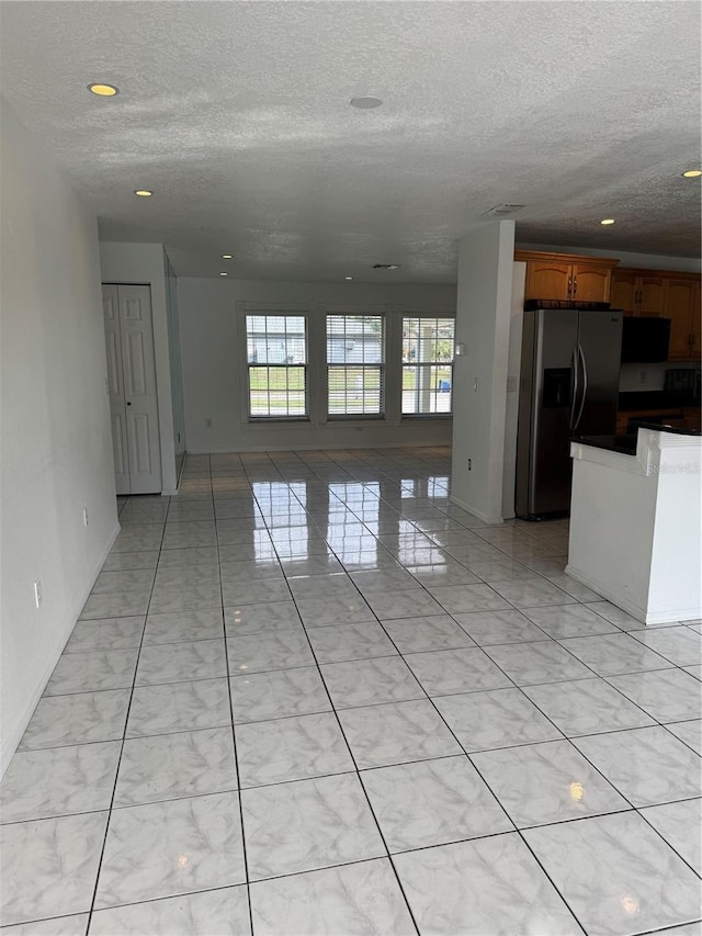 unfurnished living room with a textured ceiling