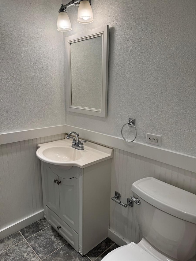 bathroom featuring tile patterned floors, vanity, and toilet