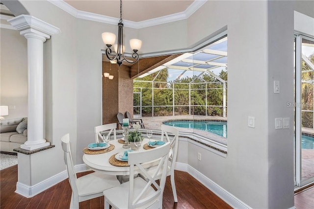 dining room with decorative columns, dark wood-type flooring, crown molding, and a notable chandelier