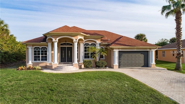 mediterranean / spanish-style house with a front yard and a garage