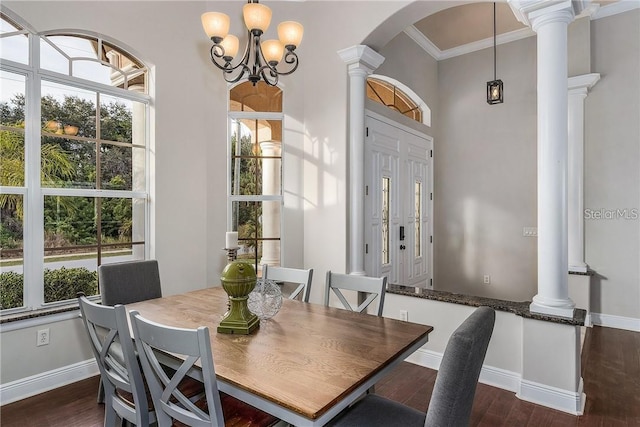 dining room featuring an inviting chandelier, crown molding, and dark hardwood / wood-style floors