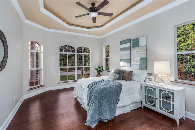 bedroom with ceiling fan, crown molding, and a tray ceiling