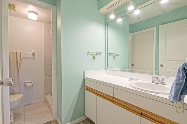 bathroom featuring tile patterned floors, vanity, toilet, and walk in shower