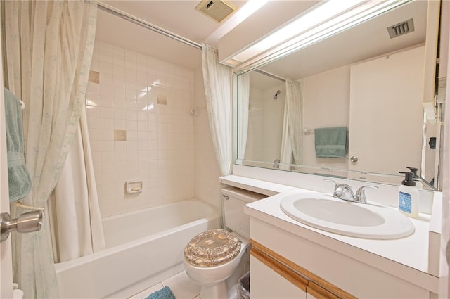 full bathroom with tile patterned floors, shower / bath combo with shower curtain, vanity, and toilet