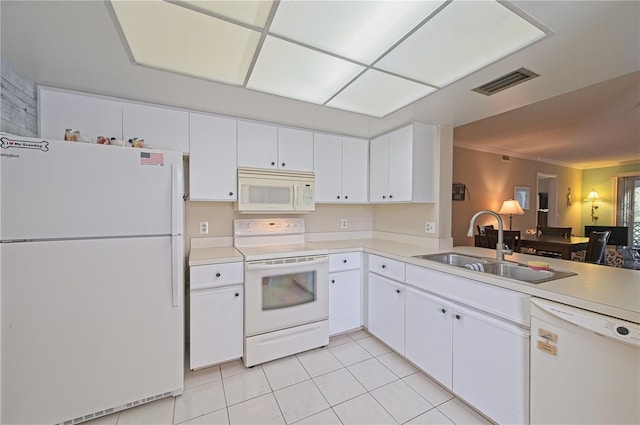 kitchen with white cabinets, white appliances, sink, and light tile patterned floors