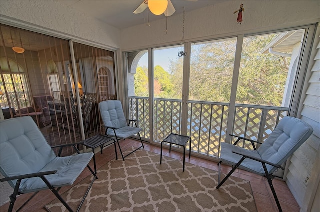 sunroom featuring ceiling fan