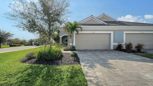 view of front of home featuring a front yard and a garage