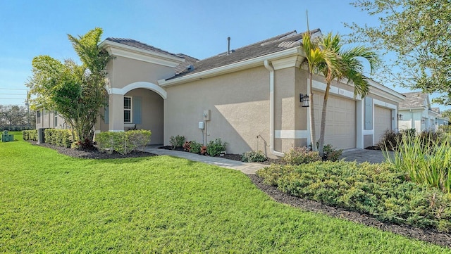 view of home's exterior with a lawn and a garage