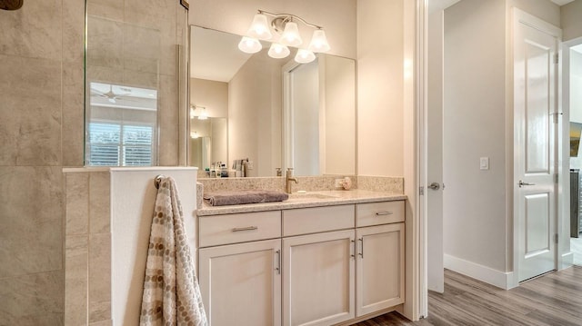 bathroom featuring hardwood / wood-style flooring, vanity, and ceiling fan