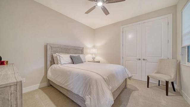 carpeted bedroom with a closet, ceiling fan, and lofted ceiling